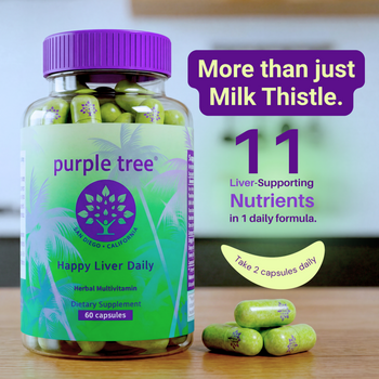 A bottle of Purple Tree Happy Liver Daily herbal supplement capsules on a wooden surface, with three green capsules placed beside it. The bottle has a purple cap and a green-to-purple label with palm tree graphics.